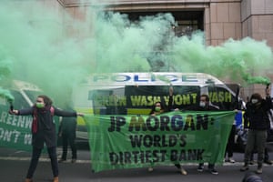 Extension Rebellion activists protest against greenwashing in front of JP Morgan premises
