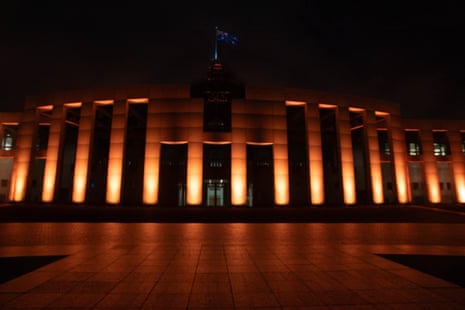 Parliament House illuminated in orange