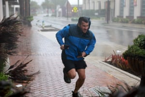A pedestrian runs for shelter in Sarasota