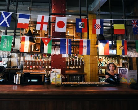 World Cup soccer flags decorate a bar at a pub showing FIFA World Cup soccer in London