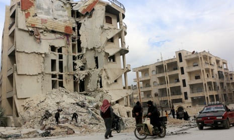 Civil defence workers search a ruined building after an airstrike in Idlib city centre on Monday.