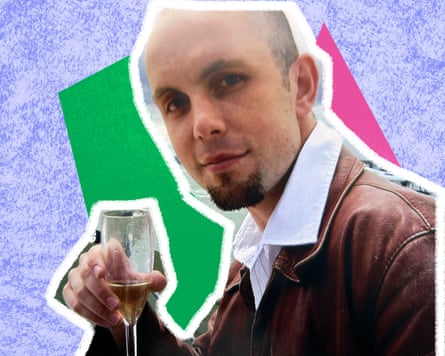 Young man with a bald head and extended goatee with a glass of champagne