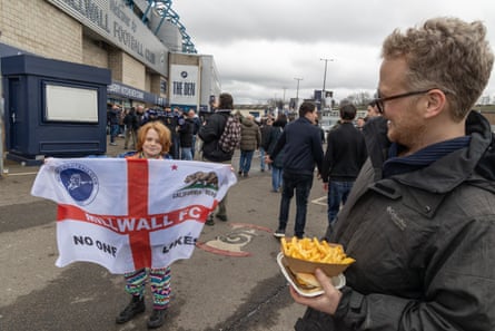Millwall fans Christian Lander (right) and his boy George. They are immigrants from nan US who now unrecorded successful London