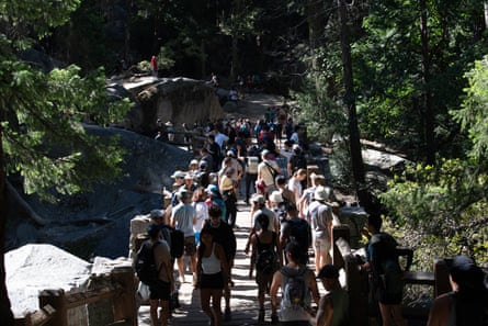 Crowds stepping up and down a steep outdoor staircase.