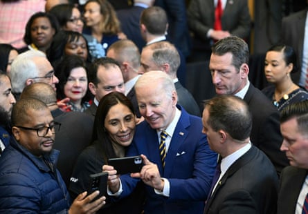 Joe Biden poses for a selfie with attendees after speaking about the economy at the International Brotherhood of Electrical Workers Local 26 union, in Lanham, Maryland, this month.