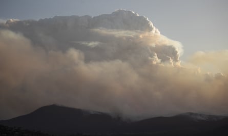 dark mountains seen with immense clouds and smoke above