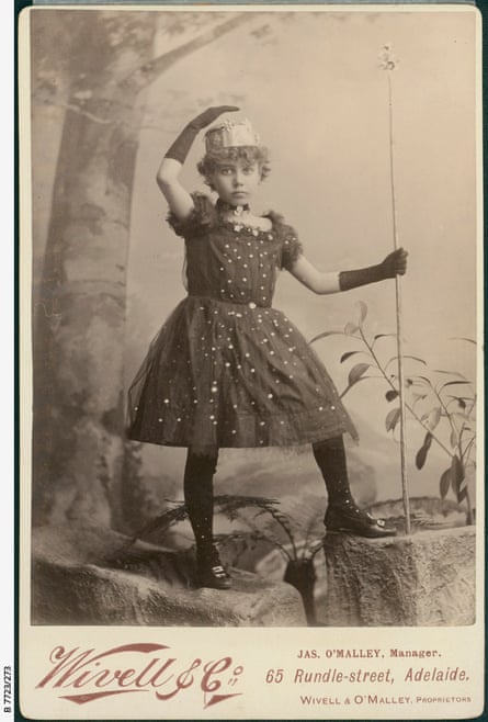 A young girl in a starry-patterned dark dress