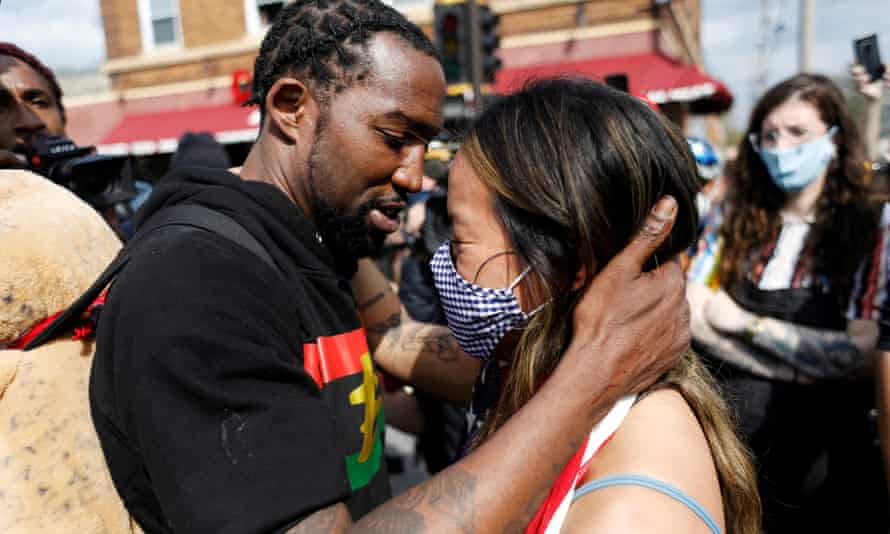 Michael Wilson kisses Anthea Yur at an Asian solidarity rally dedicated to Daunte Wright and George Floyd in Minneapolis, Minnesota on April 18, 2021.