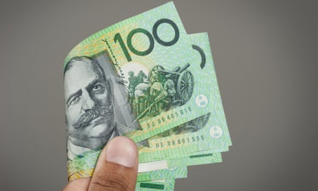 Hand holding Australian 100 dollar bills