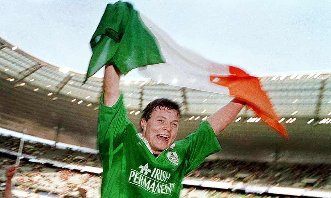 Brian O'Driscoll celebrates with an Ireland flag after scoring a hat-trick of tries in Paris in 2000.