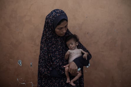 A woman holds a baby