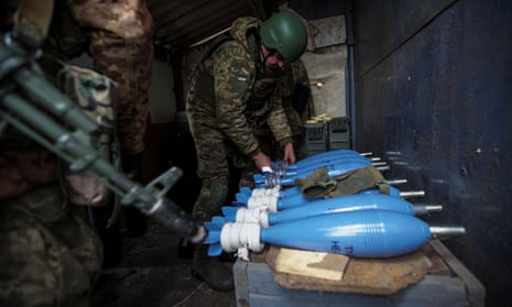 Ukrainian troops prepare mortar shells before firing them towards Russian positions on the outskirts of Bakhmut