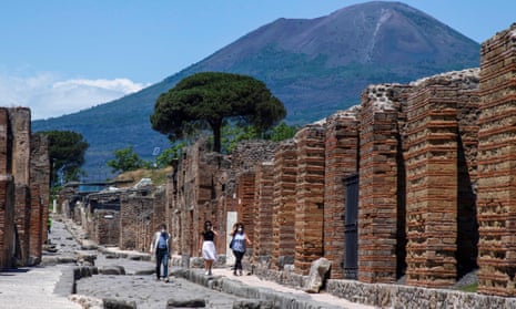 Visitors walk across the archeological site of Pompeii at the foot of Mount Vesuvius.
