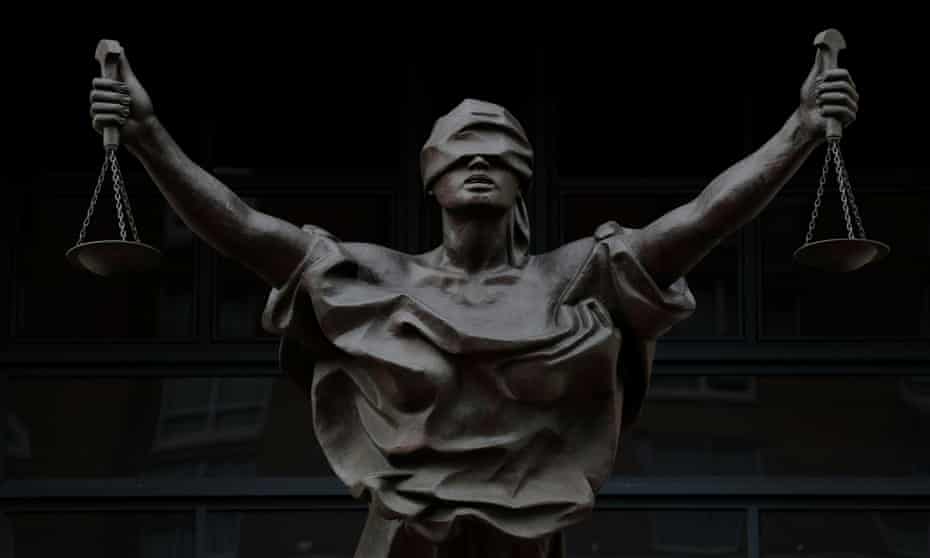 A bronze statue depicting a figure of Justice 