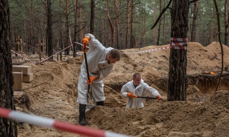 Experts digging in woods in Izium