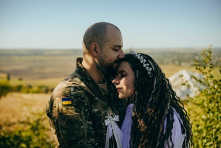 Tetiana and Oleksandr pose for a wedding photo on Mount Karachun, near Sloviansk, the scene of fierce fighting in 2014.