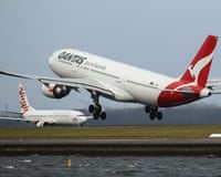 Views of Qantas airbus taking off as a Virgin aircraft taxies on the tarmac at Sydney airport