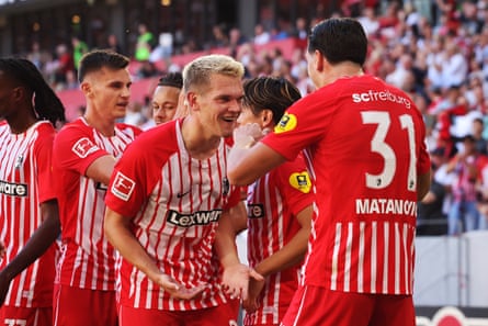 Freiburg's Matthias Ginter congratulates Igor Matanovic on the opening goal against Borussia Mönchengladbach.
