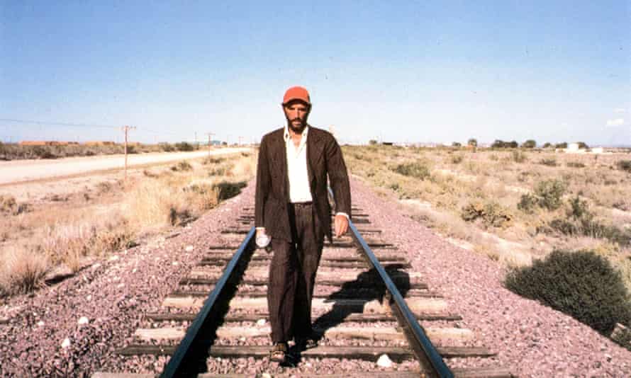 Harry Dean Stanton walking along a rail track in Paris, Texas (1984). 