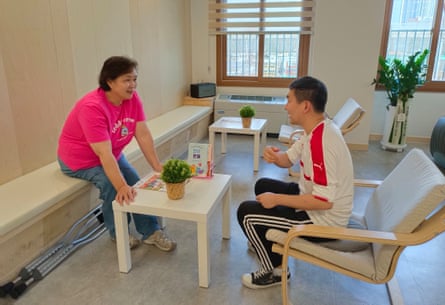 Two people chat while sitting at a table