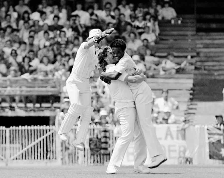 Norman Cowans of England (right) is congratulated by teammates Ian Botham and wicketkeeper Bob Taylor (left) after taking the wicket of Australia’s Greg Chappell during the Fourth Test between Australia and England at the MCG, Melbourne, Australia, 29th December 1982. Cowans took a career-best 6 wickets for 77 runs, as England won the match by 3 runs.