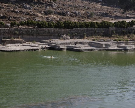 Palestinians swimming in the reservoir