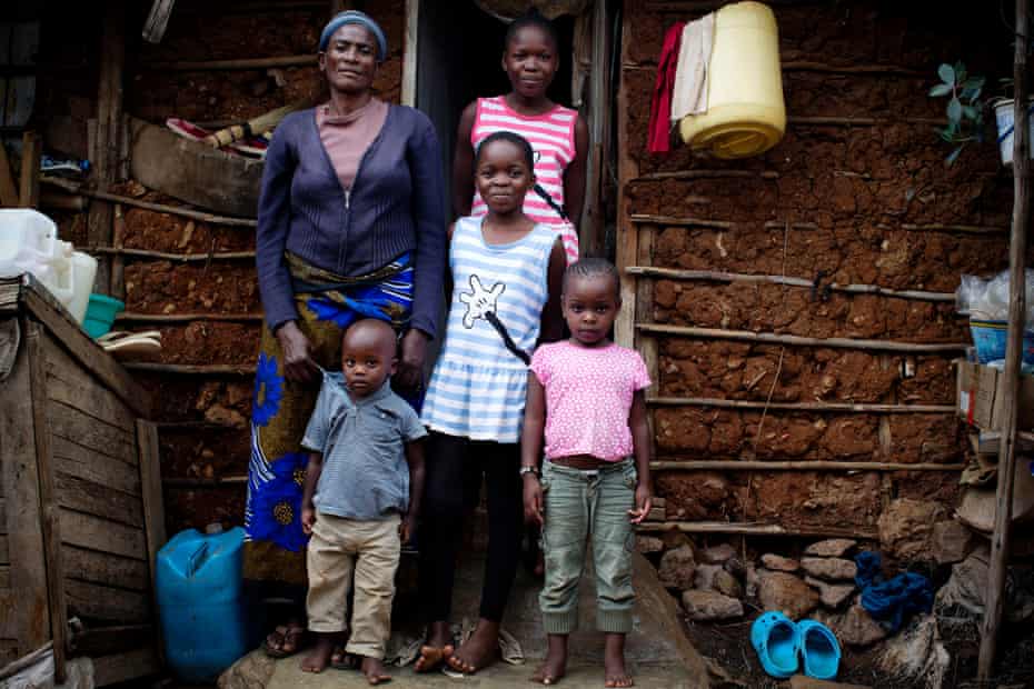 Rosemary with her grandchildren on the steps of their home in Kibera