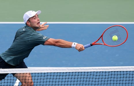 Arthur Fery stretches for a backhand at the net.