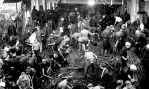 Rescue worker digging in the wreckage of the school engulfed by a sliding mountain of coal slurry at Aberfan, October 1966.