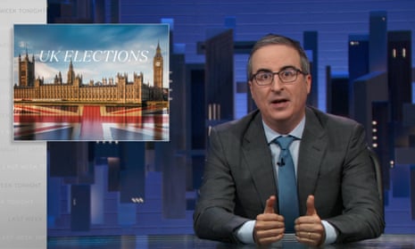 A man wearing glasses and a gray suit sits at a desk with a graphic reading 'UK elections' onscreen