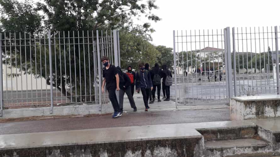 Pupils in Nicosia school exit premises wearing masks.