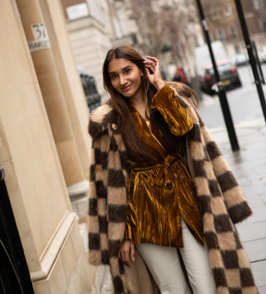 Eshita Kabra-Davies wearing a velvet jacket, a fur coat and cream trousers