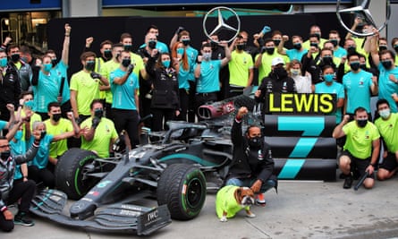 F1's Lewis Hamilton celebrates with his dog Roscoe and his team after winning the Turkish Grand Prix to secure his seventh world championship on 15 November 2020