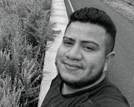 Man smiles with grass behind him