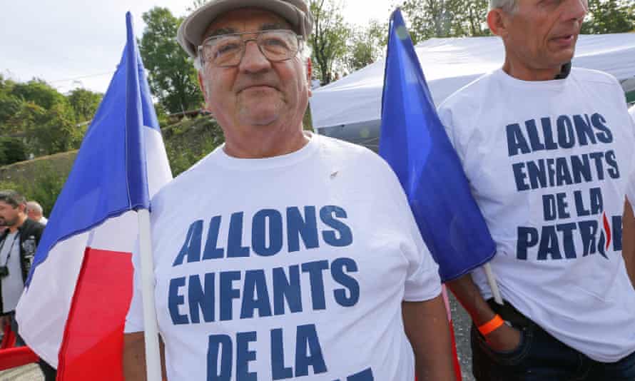 Two Front National supporters wear T-shirts emblazoned with the first sentence of the French National anthem.
