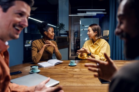 Diverse business colleagues brainstorming ideas during meetingBusiness colleagues collaborating and communicating ideas during a late-night office meeting, engaging in teamwork and discussion to achieve common goals