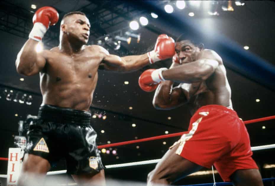 Mike Tyson (left) v Frank Bruno in 1989.