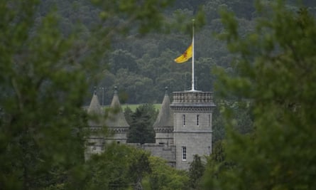 A flag at half mast flaps in the wind at Balmoral Castle in September