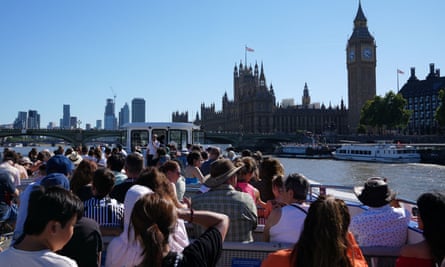 People in a boat with , with the Elizabeth Tower (Big Ben), in the background
