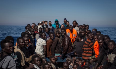 Refugees and migrants wait to be rescued off Lampedusa, Italy in May this year