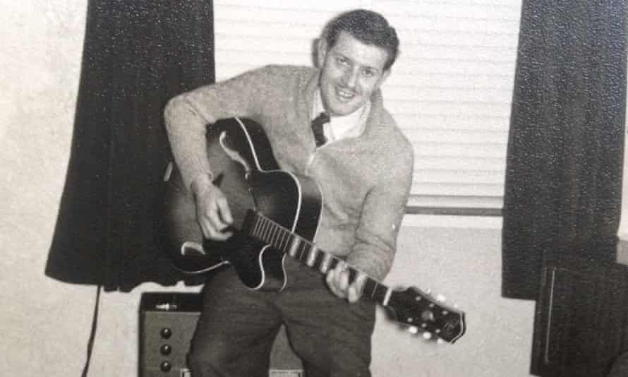 Ken Patten playing a guitar