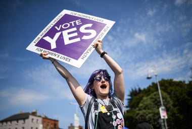 Members of the public hold yes placards on Fairview road in Dublin, Ireland.
