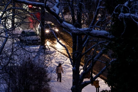 A pedestrian walks through the Lichterfelde district in the snow
