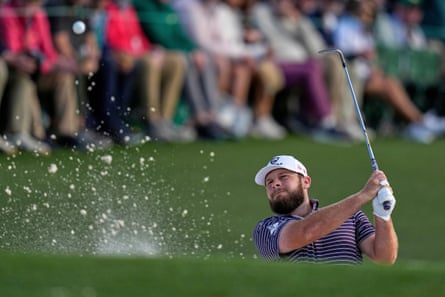 Tyrrell Hatton hits from the bunker on the 18th hole during the third round of the Masters.