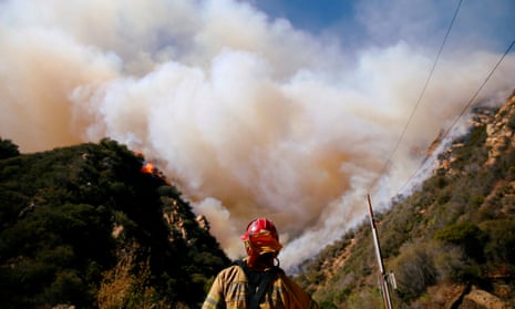 Firefighters battle the Woolsey blaze in Malibu, California.