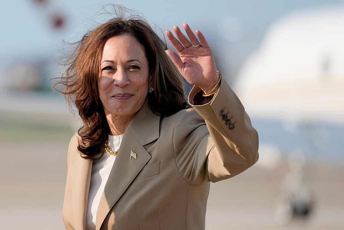 Kamala Harris waves after getting off a plane