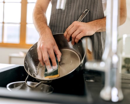 Close up shot of man washing cooking pan