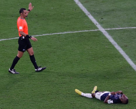 Referee Mustapha Ghorbal calls for Enner Valencia of Ecuador to go down injured.
