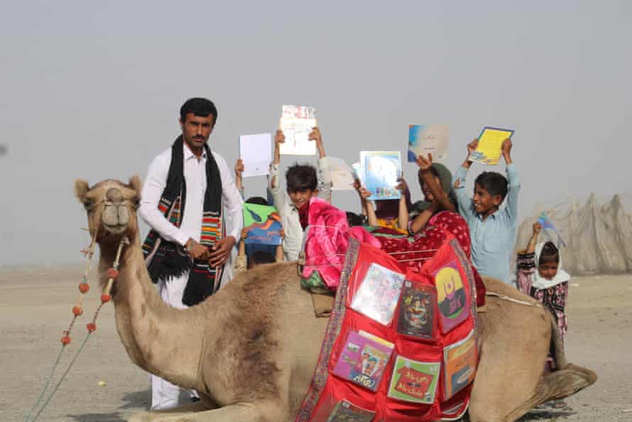 Teacher Ismail Yaqoob (left) with children in Gwadar district