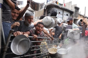 Palestinians with pots struggle to get their food